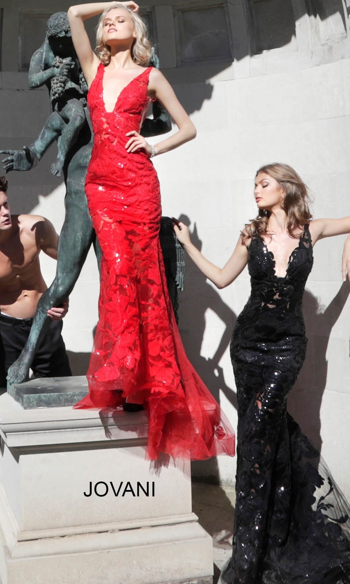 Two models pose in long, sleeveless Jovani Embroidered Long Prom Dress with Sequins designs, featuring floral embroidery and sequin detailing in red and black.